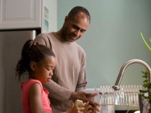 Father and daughter in kitchen