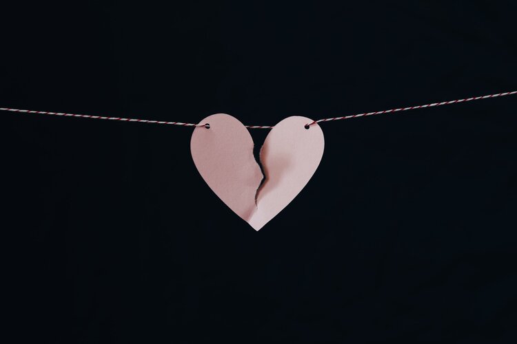 Torn paper heart on a string